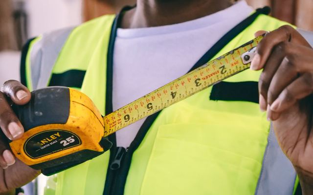 Hands holding a tape measure